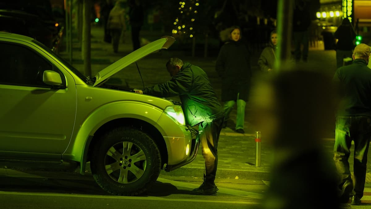 Roadside assistance vehicle helping a stranded driver at night